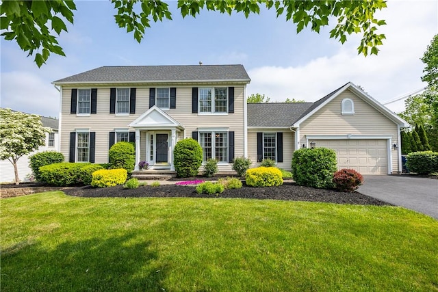 2 Princeton Ln, Perinton, NY 14450 - colonial inspired home with a garage, asphalt driveway, and a front lawn