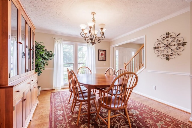 2 Princeton Ln, Perinton, NY 14450 - dining room with a chandelier, ornamental molding, a textured ceiling, light wood-style floors, and stairway