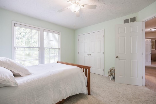 2 Princeton Ln, Perinton, NY 14450 - carpeted bedroom featuring a closet, ceiling fan, and a textured ceiling