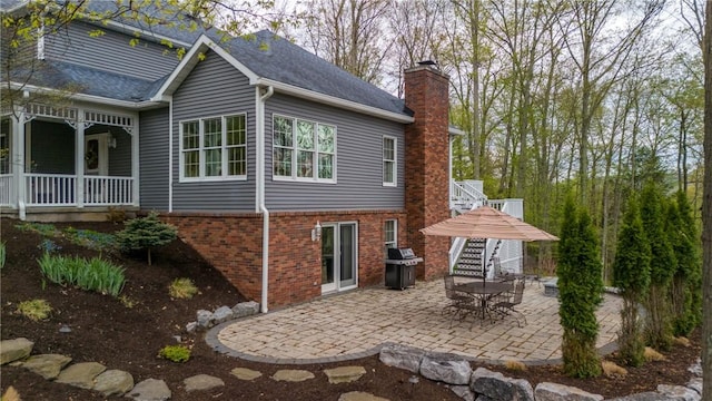 256 Queen Esther Dr, Sayre, PA 18840 - view of property exterior with a chimney, brick siding, and a patio
