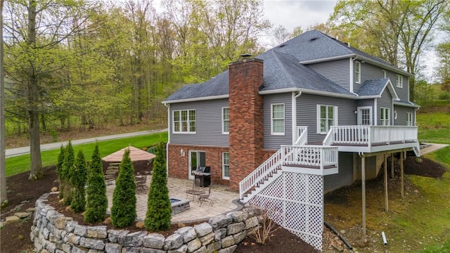 256 Queen Esther Dr, Sayre, PA 18840 - back of house featuring a patio, a wooden deck, stairs, a chimney, and a shingled roof