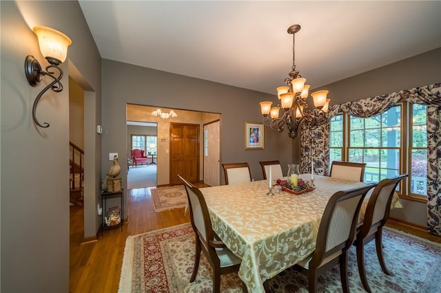 256 Queen Esther Dr, Sayre, PA 18840 - dining space featuring a chandelier, wood finished floors, and baseboards