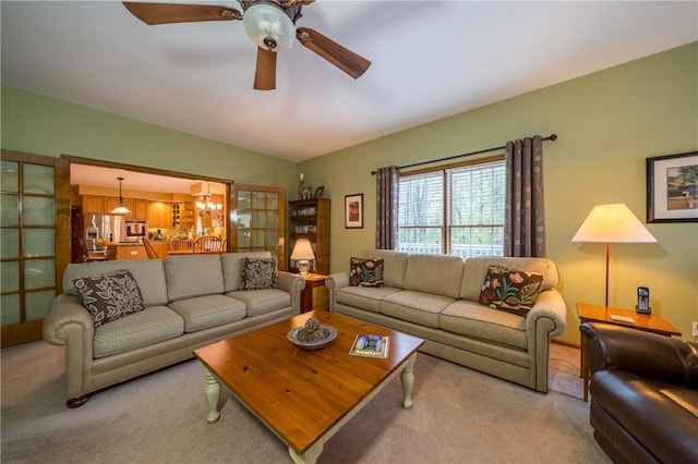 256 Queen Esther Dr, Sayre, PA 18840 - living area with light colored carpet, ceiling fan, and a chandelier