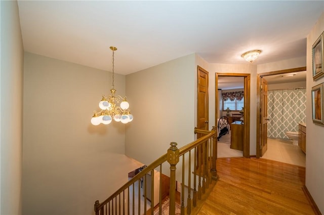 256 Queen Esther Dr, Sayre, PA 18840 - hall with an upstairs landing, light wood finished floors, and a chandelier