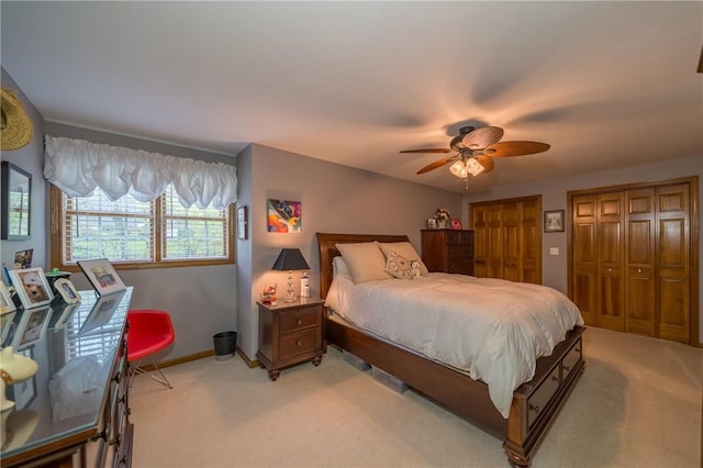 256 Queen Esther Dr, Sayre, PA 18840 - bedroom featuring light carpet, multiple closets, a ceiling fan, and baseboards