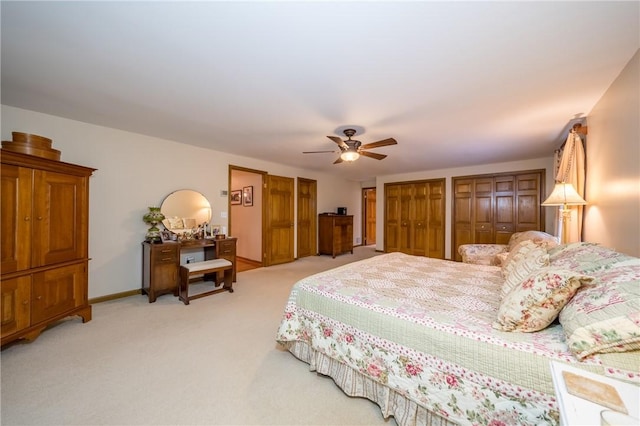 256 Queen Esther Dr, Sayre, PA 18840 - bedroom featuring two closets, light carpet, ceiling fan, and baseboards