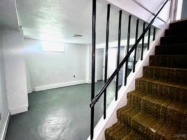226 Darlington Rd, Syracuse, NY 13208 - staircase featuring concrete floors and baseboards