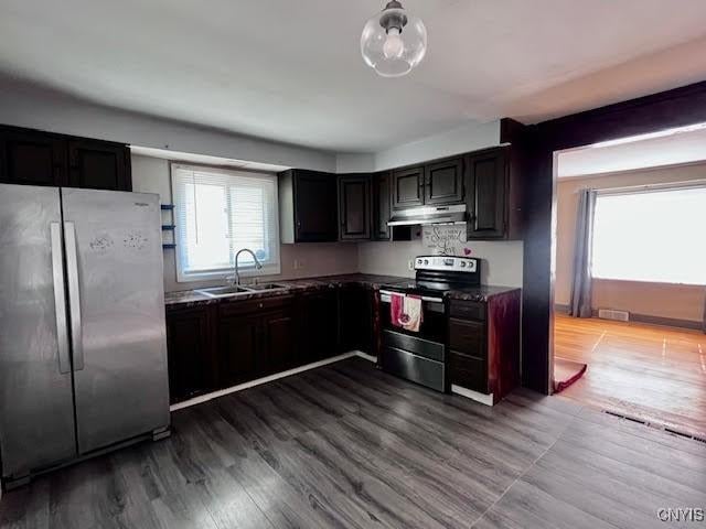 226 Darlington Rd, Syracuse, NY 13208 - kitchen with freestanding refrigerator, range with electric cooktop, a sink, under cabinet range hood, and dark countertops