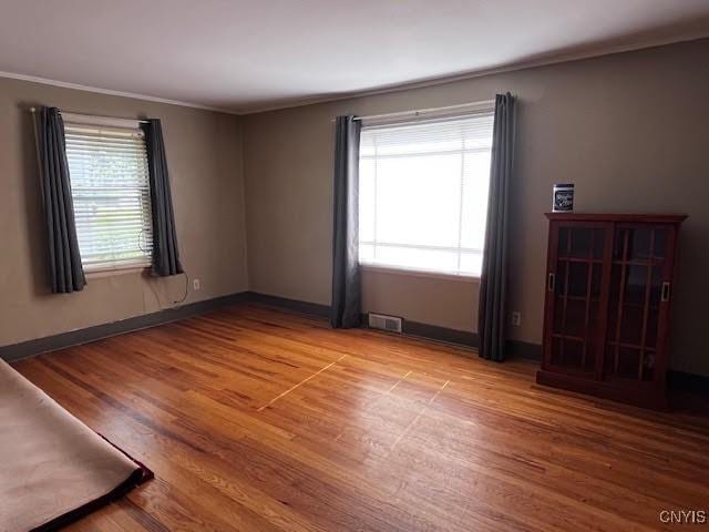 226 Darlington Rd, Syracuse, NY 13208 - empty room with wood finished floors, crown molding, and baseboards