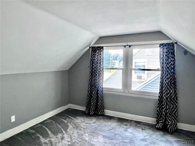 226 Darlington Rd, Syracuse, NY 13208 - additional living space featuring vaulted ceiling, baseboards, and carpet flooring
