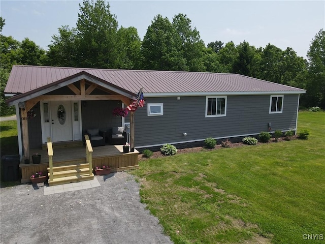 8 Office Rd, Fowler, NY 13642 - view of front of property featuring a front yard, metal roof, and a porch