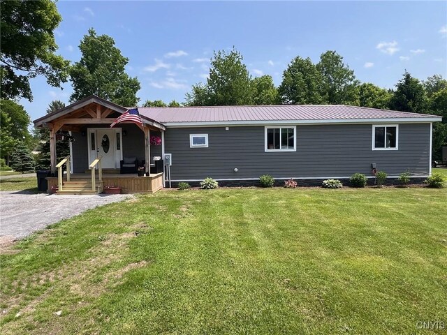 8 Office Rd, Fowler, NY 13642 - view of front of property with a porch, a front yard, and metal roof