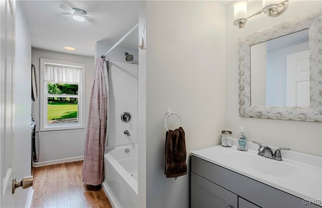 3838 Dawes Ave, Kirkland, NY 13323 - full bath featuring wood finished floors, vanity, shower / bath combo, and baseboards