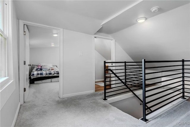 3838 Dawes Ave, Kirkland, NY 13323 - stairway featuring carpet, vaulted ceiling, and baseboards