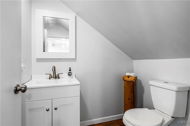 3838 Dawes Ave, Kirkland, NY 13323 - half bathroom featuring vaulted ceiling, vanity, and toilet