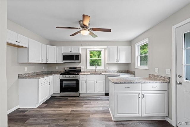308 Lewis St, Syracuse, NY 13204 - kitchen with appliances with stainless steel finishes, a sink, healthy amount of natural light, and white cabinets