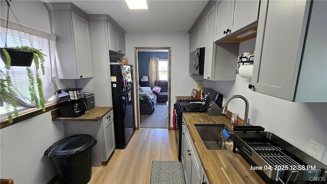 24 Pinecrest Rd, Whitestown, NY 13492 - kitchen featuring butcher block counters, black appliances, light wood-style floors, a sink, and gray cabinets