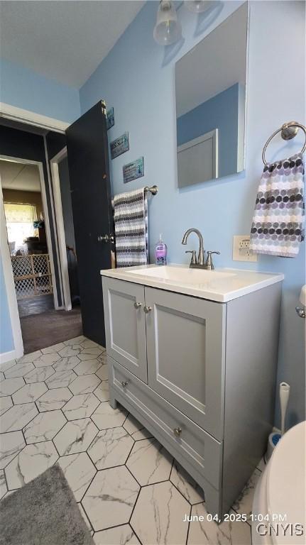 24 Pinecrest Rd, Whitestown, NY 13492 - bathroom featuring toilet, vanity, and marble look tiles