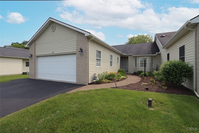 207 Falling Brook Path, Manlius, NY 13066 - ranch-style home featuring a garage, asphalt driveway, a front yard, and brick siding