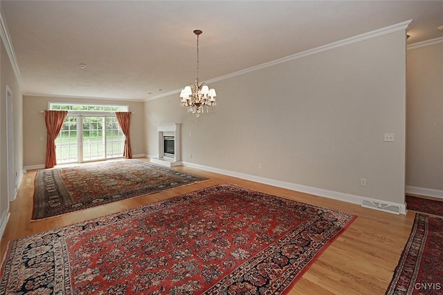 207 Falling Brook Path, Manlius, NY 13066 - living room featuring ornamental molding, light wood finished floors, a chandelier, baseboards, and a glass covered fireplace
