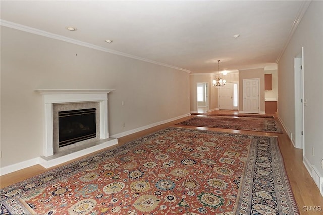 207 Falling Brook Path, Manlius, NY 13066 - unfurnished living room with a chandelier, ornamental molding, baseboards, light wood-style floors, and a fireplace