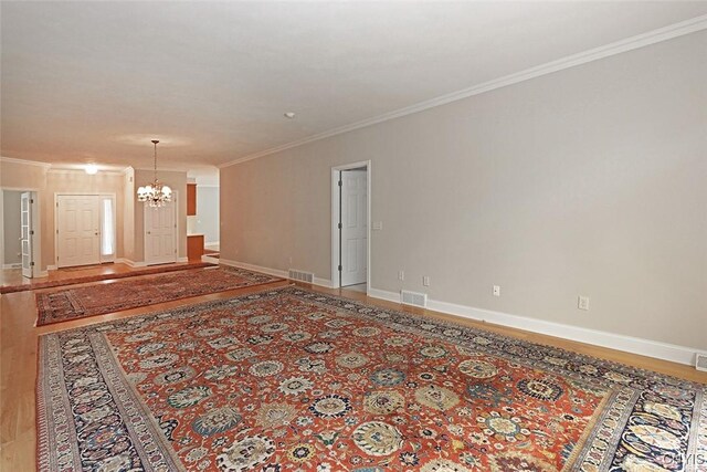 207 Falling Brook Path, Manlius, NY 13066 - spare room featuring a chandelier, crown molding, light wood-style flooring, and baseboards