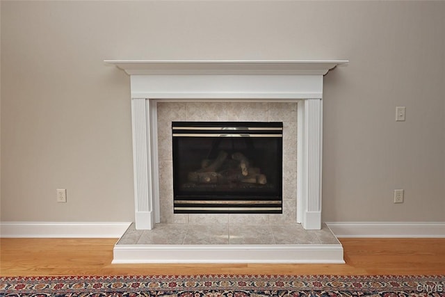 207 Falling Brook Path, Manlius, NY 13066 - detailed view of wood finished floors, baseboards, and a tile fireplace