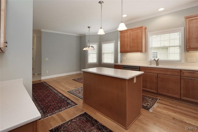 207 Falling Brook Path, Manlius, NY 13066 - kitchen featuring light wood-style flooring, a center island, ornamental molding, light countertops, and pendant lighting