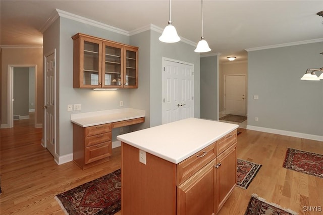 207 Falling Brook Path, Manlius, NY 13066 - kitchen featuring light wood-style flooring, glass insert cabinets, light countertops, crown molding, and baseboards
