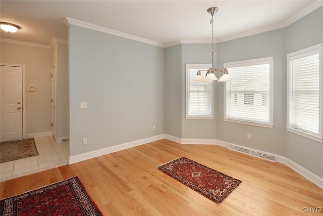 207 Falling Brook Path, Manlius, NY 13066 - unfurnished dining area featuring light wood-type flooring, a chandelier, crown molding, and baseboards