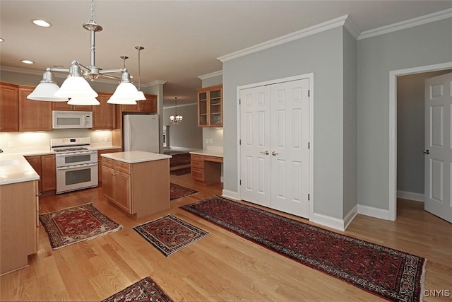 207 Falling Brook Path, Manlius, NY 13066 - kitchen with white appliances, ornamental molding, light wood-style flooring, a kitchen island, and light countertops