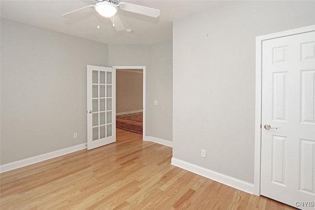 207 Falling Brook Path, Manlius, NY 13066 - empty room with light wood-style floors, a ceiling fan, baseboards, french doors, and a smoke detector