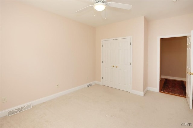 207 Falling Brook Path, Manlius, NY 13066 - unfurnished bedroom with light colored carpet, a closet, baseboards, and a ceiling fan