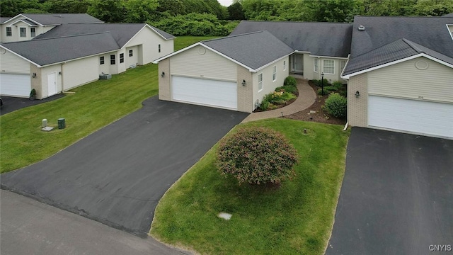 207 Falling Brook Path, Manlius, NY 13066 - view of front facade featuring asphalt driveway, an attached garage, a front yard, and central AC unit