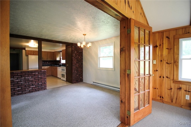 465 Blanding Rd, Sherburne, NY 13460 - unfurnished living room featuring a baseboard radiator, a chandelier, light colored carpet, a textured ceiling, and wood walls