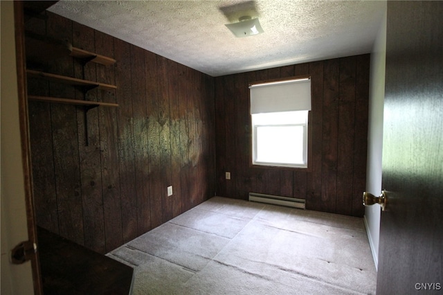 465 Blanding Rd, Sherburne, NY 13460 - unfurnished room with a baseboard radiator, wooden walls, carpet flooring, and a textured ceiling