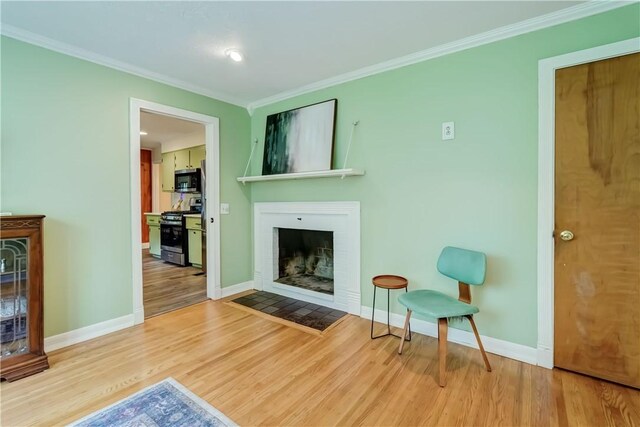 12 Edgewood Dr, Penfield, NY 14526 - living room featuring ornamental molding, a fireplace with flush hearth, wood finished floors, and baseboards
