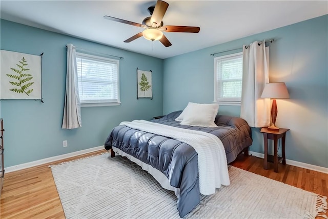 12 Edgewood Dr, Penfield, NY 14526 - bedroom featuring multiple windows, wood finished floors, and baseboards