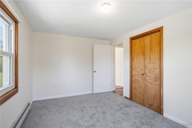 5750 Sentinel Heights Rd, Onondaga, NY 13078 - unfurnished bedroom featuring a baseboard heating unit, carpet floors, a closet, and baseboards
