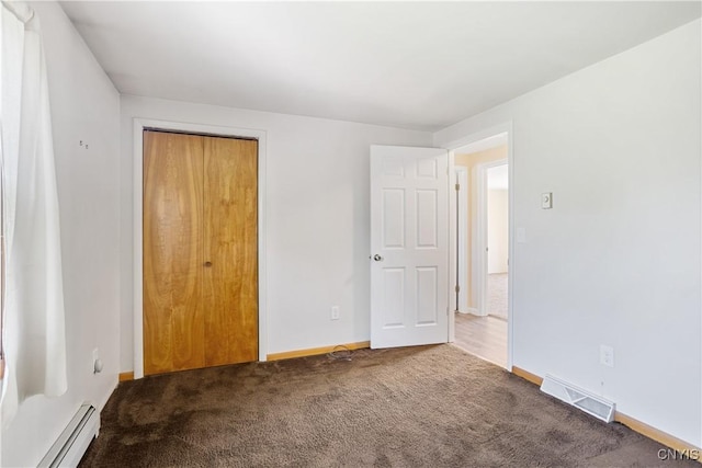 5750 Sentinel Heights Rd, Onondaga, NY 13078 - unfurnished bedroom featuring a baseboard heating unit, carpet, baseboards, and a closet