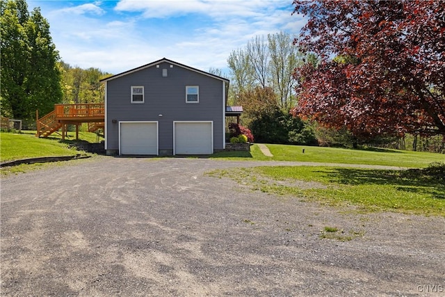 5750 Sentinel Heights Rd, Onondaga, NY 13078 - view of home's exterior featuring a deck, stairway, an attached garage, driveway, and a lawn