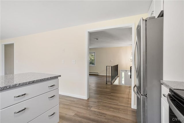 5750 Sentinel Heights Rd, Onondaga, NY 13078 - kitchen with stainless steel appliances, a baseboard radiator, wood finished floors, white cabinets, and baseboards