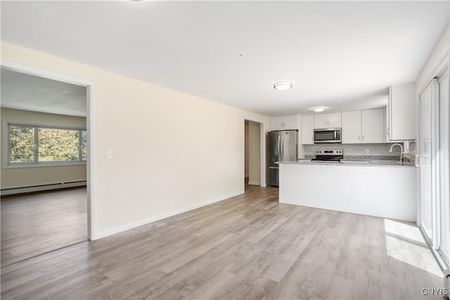 5750 Sentinel Heights Rd, Onondaga, NY 13078 - kitchen with stainless steel appliances, a baseboard heating unit, light wood-style floors, and white cabinetry
