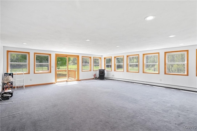 5750 Sentinel Heights Rd, Onondaga, NY 13078 - unfurnished living room with a wood stove, a baseboard heating unit, recessed lighting, and carpet