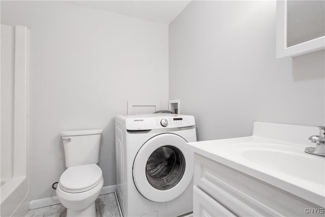 5750 Sentinel Heights Rd, Onondaga, NY 13078 - full bath with washer / dryer, marble look tile flooring, toilet, vanity, and baseboards