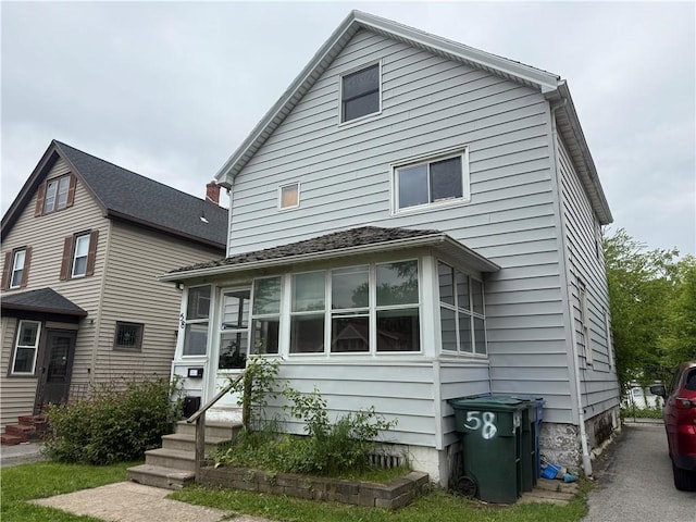 58 Mayflower St, Rochester, NY 14615 - view of front facade featuring entry steps and a sunroom