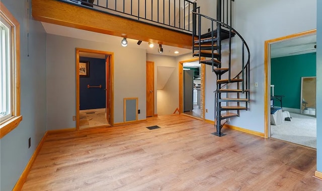 58 Mayflower St, Rochester, NY 14615 - stairs with wood finished floors, baseboards, and a towering ceiling