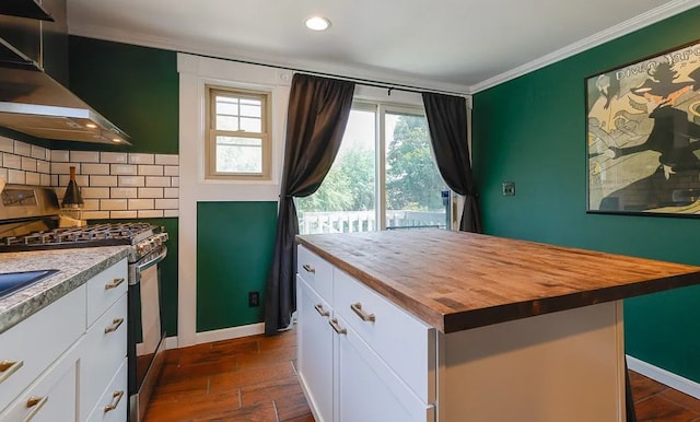 58 Mayflower St, Rochester, NY 14615 - kitchen with butcher block counters, stainless steel gas range oven, wall chimney exhaust hood, ornamental molding, and white cabinets