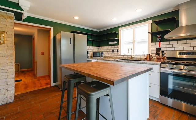 58 Mayflower St, Rochester, NY 14615 - kitchen featuring appliances with stainless steel finishes, butcher block counters, open shelves, wall chimney range hood, and a sink