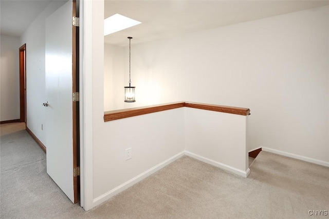 442 Summerhaven Dr N, Manlius, NY 13057 - hallway featuring carpet flooring, a skylight, and baseboards